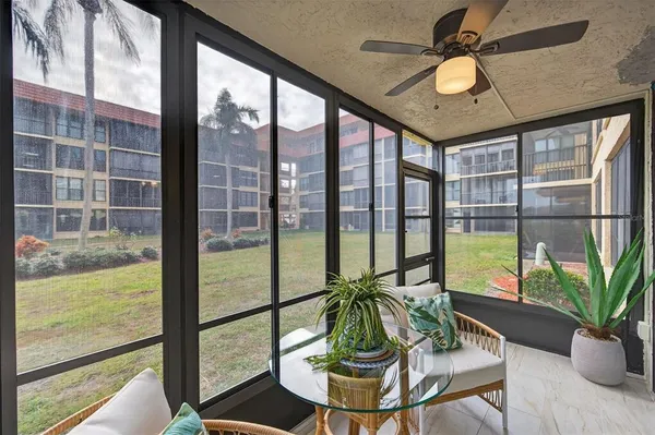 a living room with furniture and a floor to ceiling window