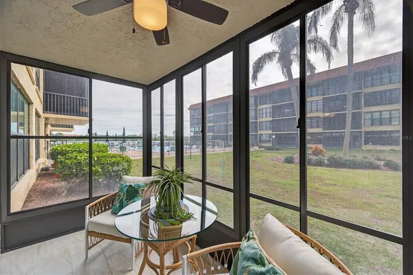 a living room filled with furniture and a potted plant