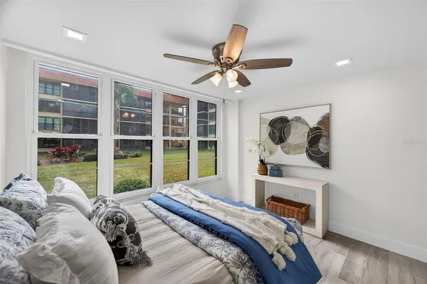 a living room with furniture potted plant and a large window