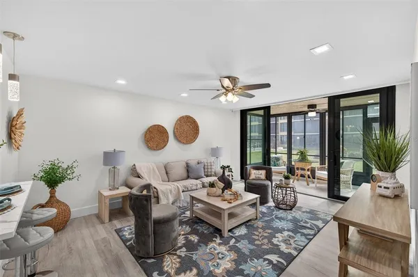 a living room with furniture and wooden floor