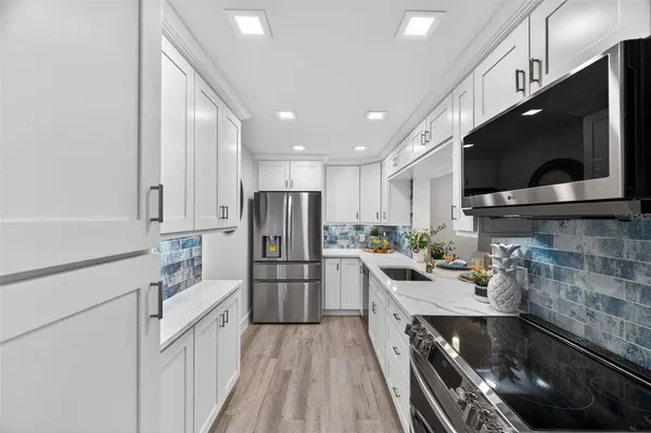 a kitchen with refrigerator and microwave