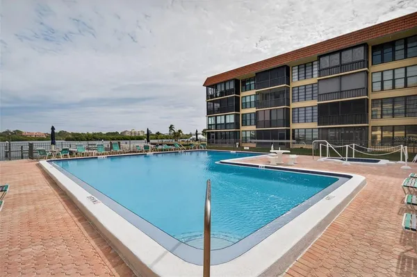 a view of swimming pool with outdoor seating and plants