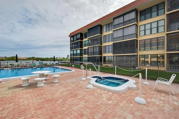 a view of swimming pool with outdoor seating and a yard in back
