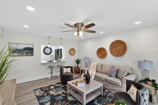 a living room with furniture and painting on the wall