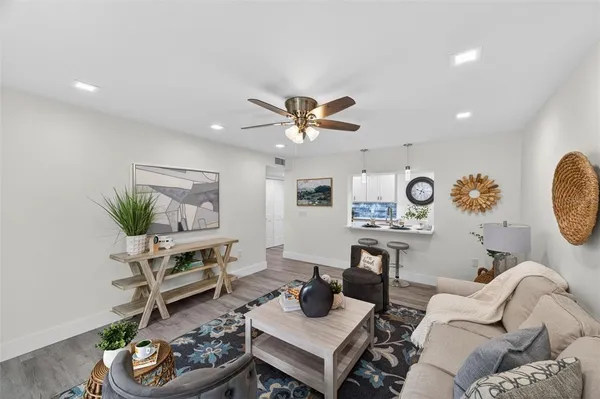 a living room with furniture and a window with garden view