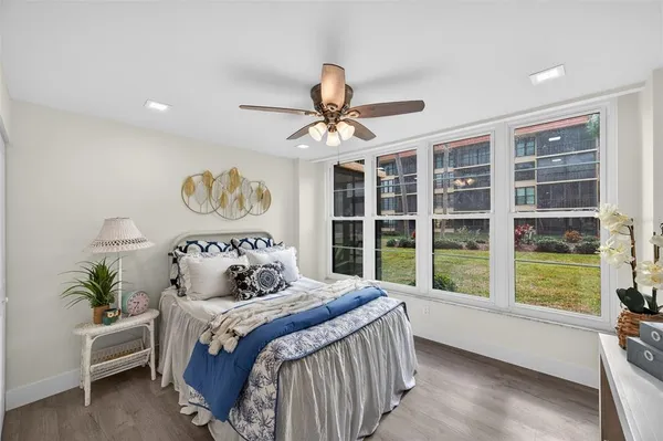 a bedroom with a large bed and a large window
