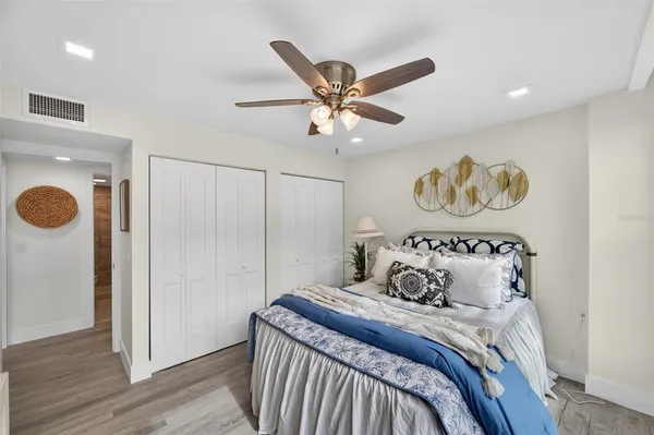 a bedroom with a bed and a chandelier