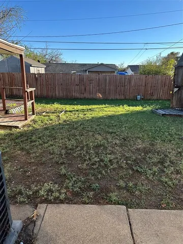 a view of a backyard with a fence