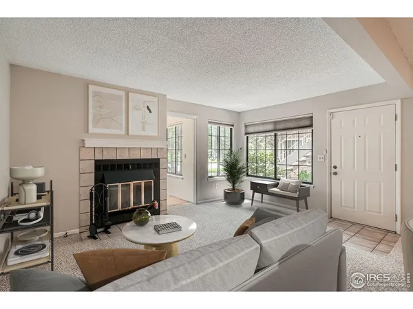 a living room with furniture and a dining table with kitchen view