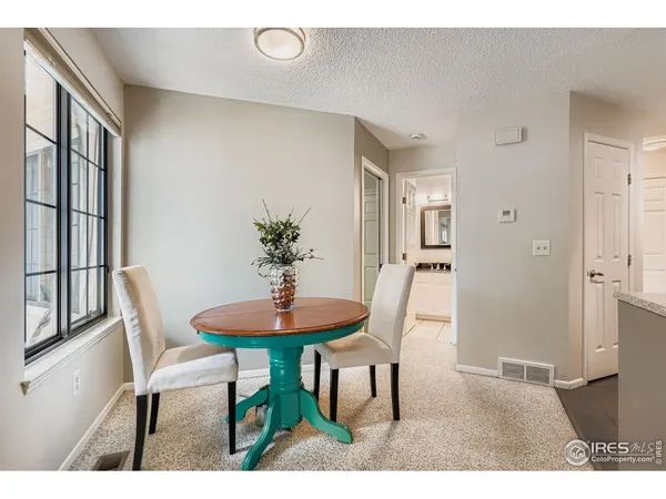 an empty room with windows and fireplace