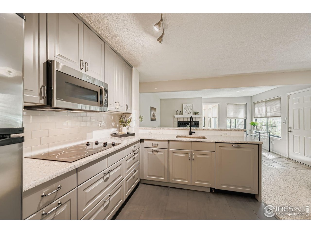 4767 White Rock Circle, Unit D Boulder, CO 80301 - Photo 15 of 41 a kitchen with stainless steel appliances a sink stove and microwave