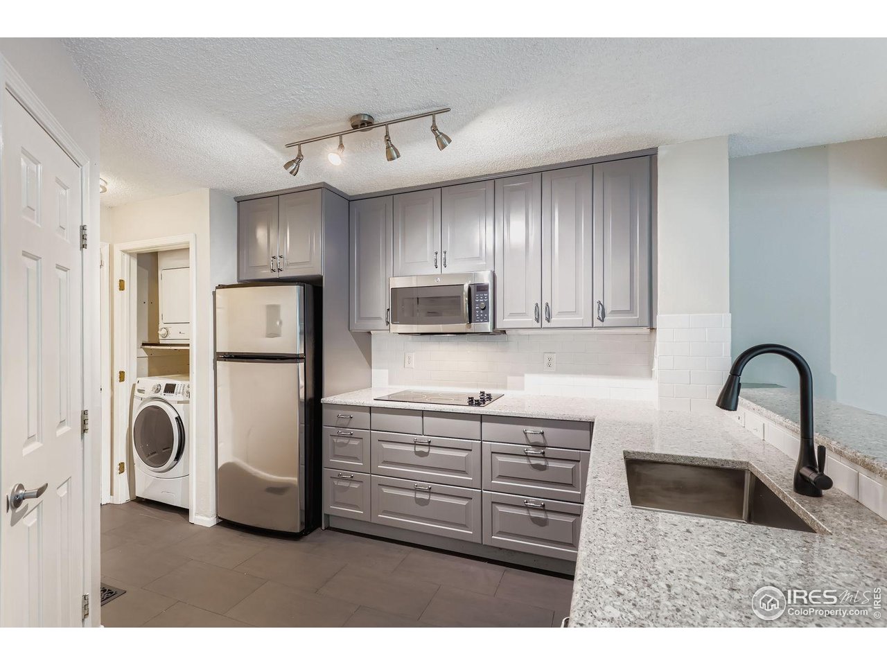 4767 White Rock Circle, Unit D Boulder, CO 80301 - Photo 17 of 41 a kitchen with refrigerator and cabinets