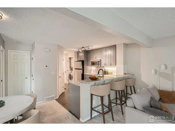 a kitchen with refrigerator and cabinets