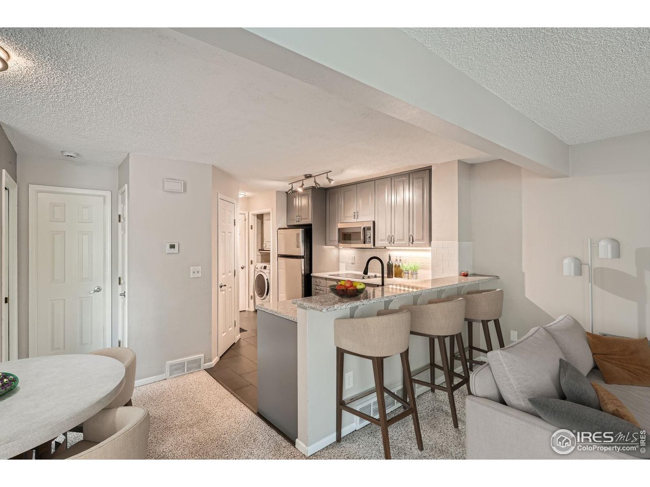 4767 White Rock Circle, Unit D Boulder, CO 80301 - Photo 18 of 41 a living room with stainless steel appliances kitchen island granite countertop furniture and a couch