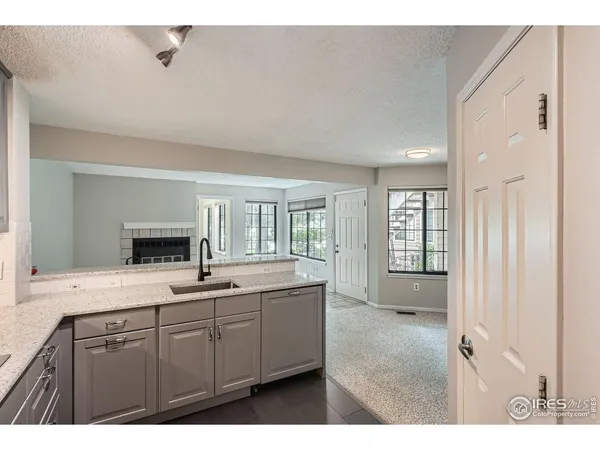 a kitchen with cabinets stainless steel appliances and a window
