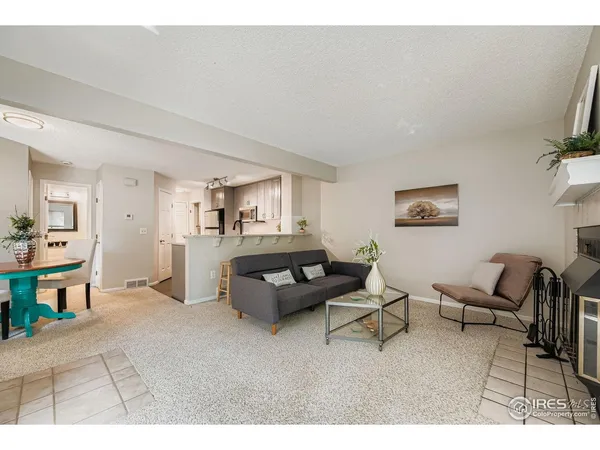 a view of a house with a flower plants and wooden fence