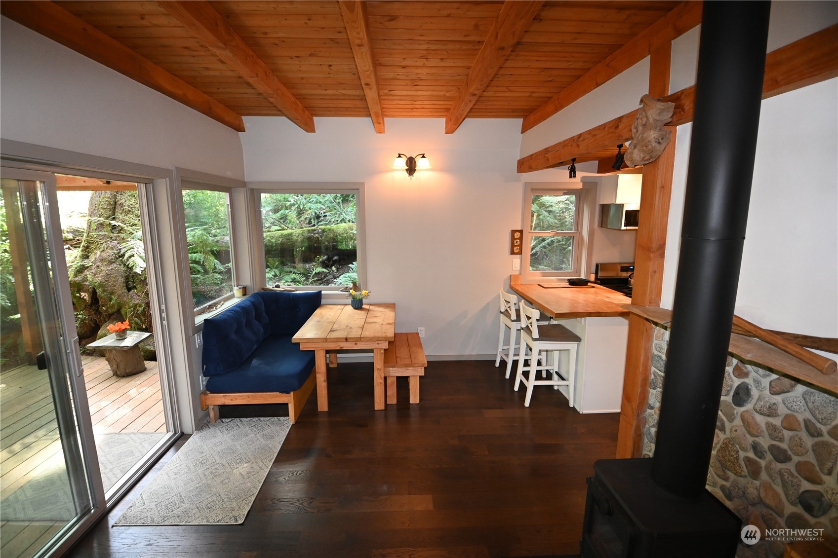 52016 South Riverside Road Gold Bar, WA 98251 - Photo 19 of 39 a living room with furniture a fireplace and a floor to ceiling window