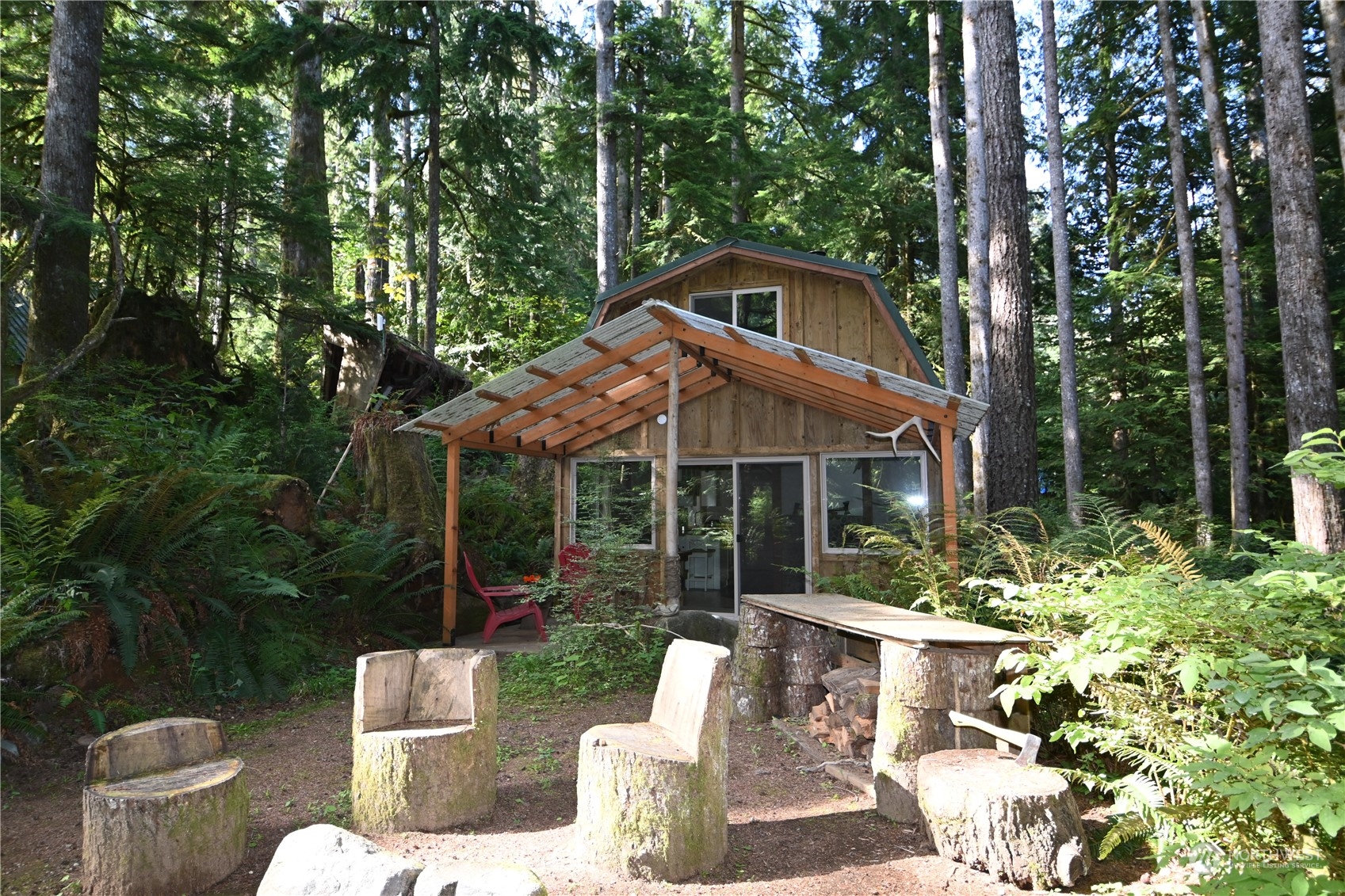 52016 South Riverside Road Gold Bar, WA 98251 - Photo 30 of 39 a view of a house with backyard sitting area and garden
