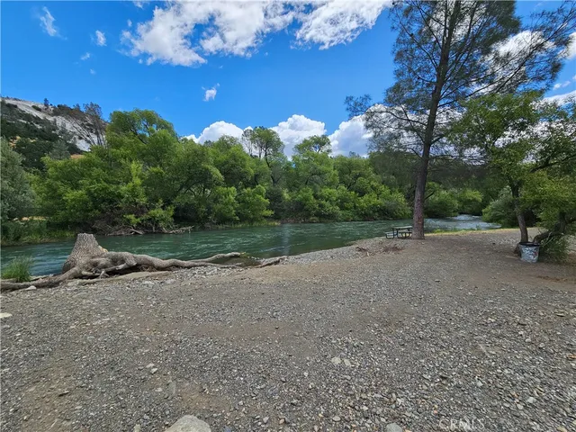 a view of a dirt road with a building in the background