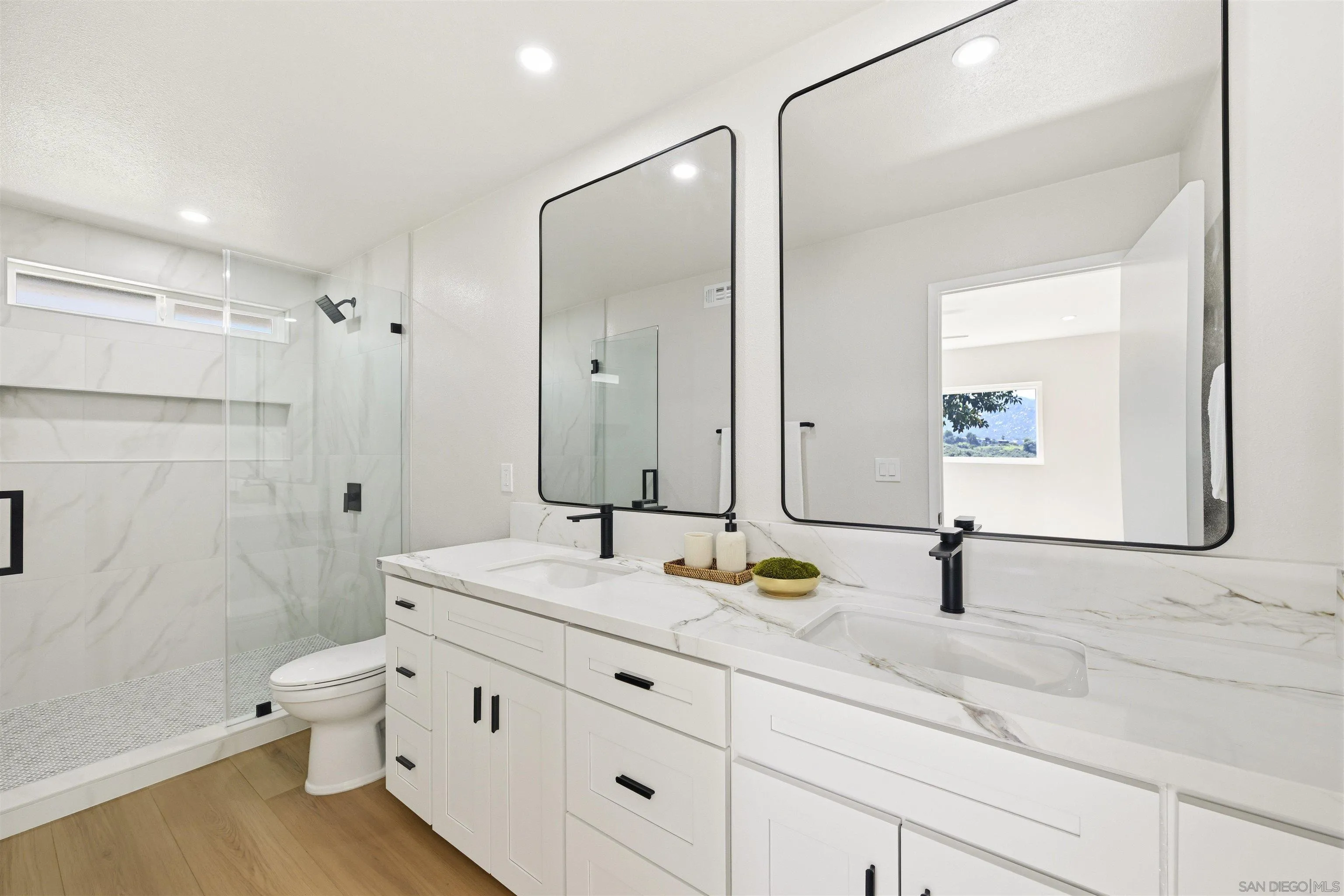 12437 Ridgeton Drive Lakeside, CA 92040 - Photo 16 of 32 a bathroom with a granite countertop sink a toilet and a large mirror