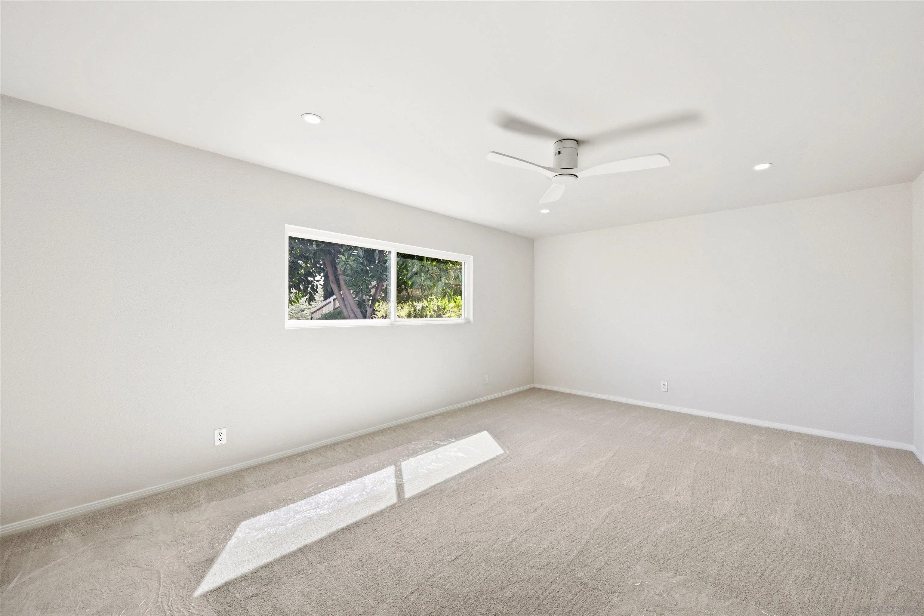 12437 Ridgeton Drive Lakeside, CA 92040 - Photo 21 of 32 an empty room with a window and a ceiling fan