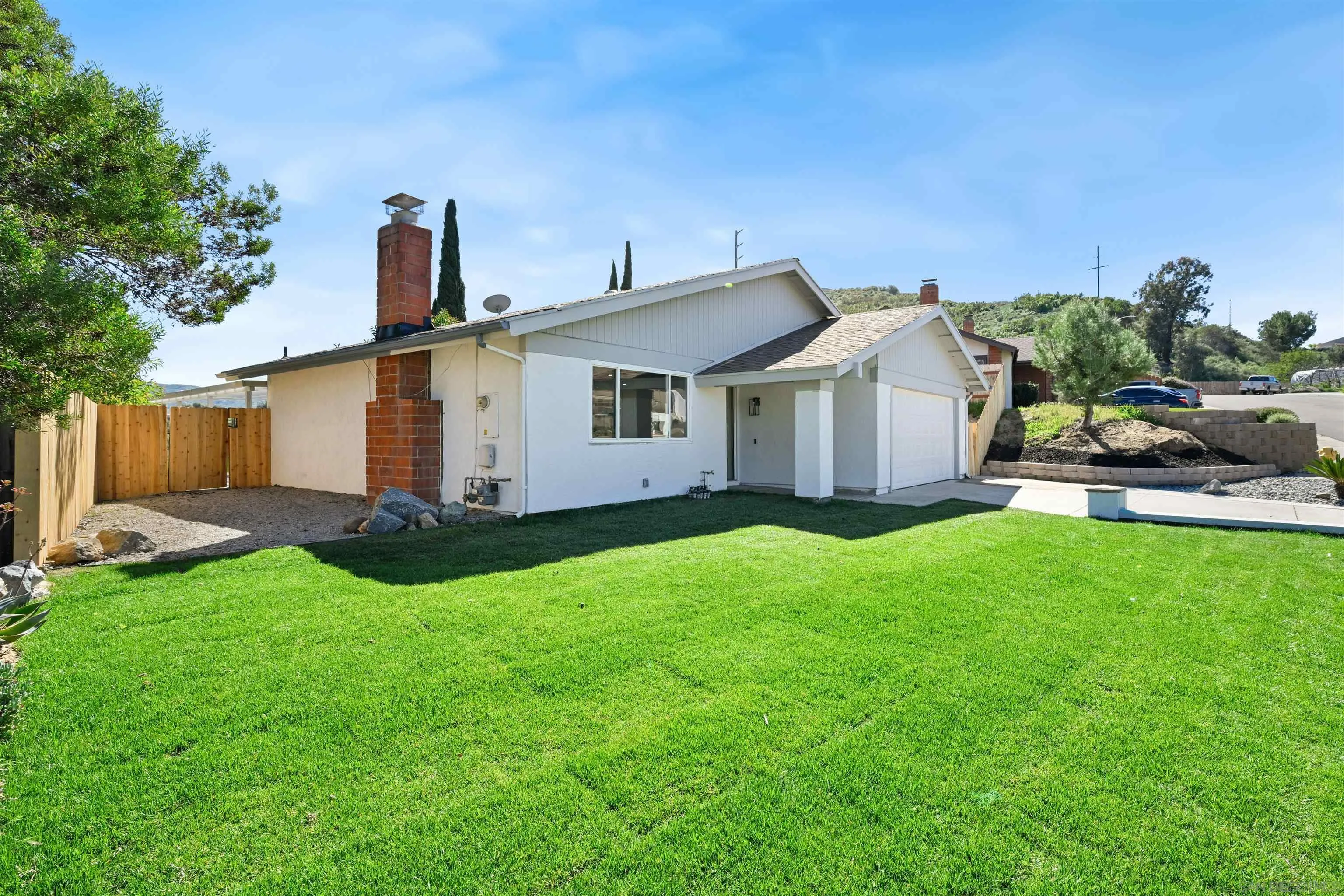 12437 Ridgeton Drive Lakeside, CA 92040 - Photo 31 of 32 a front view of a house with a garden and plants