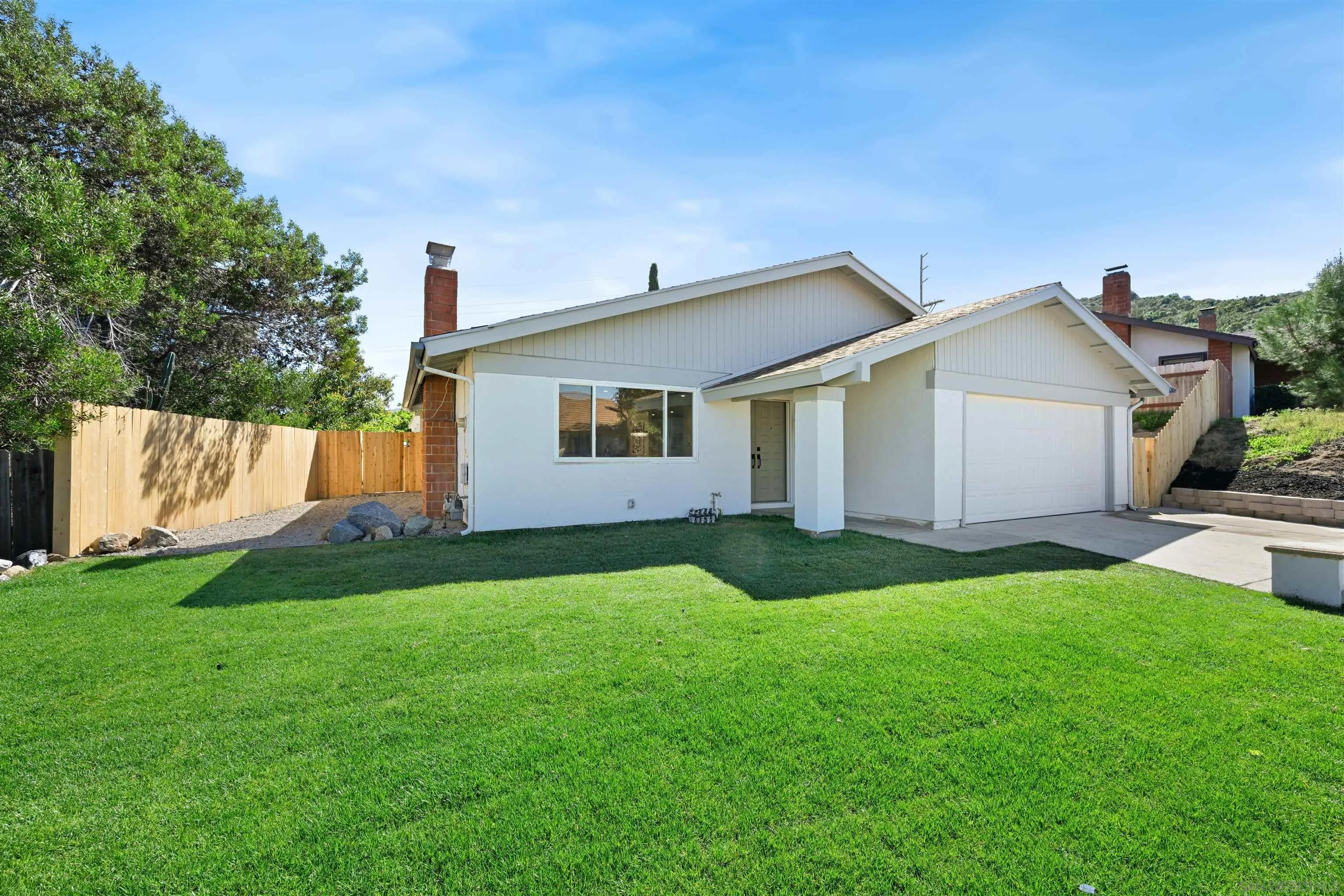 12437 Ridgeton Drive Lakeside, CA 92040 - Photo 4 of 32 a view of a house with a yard and a garage