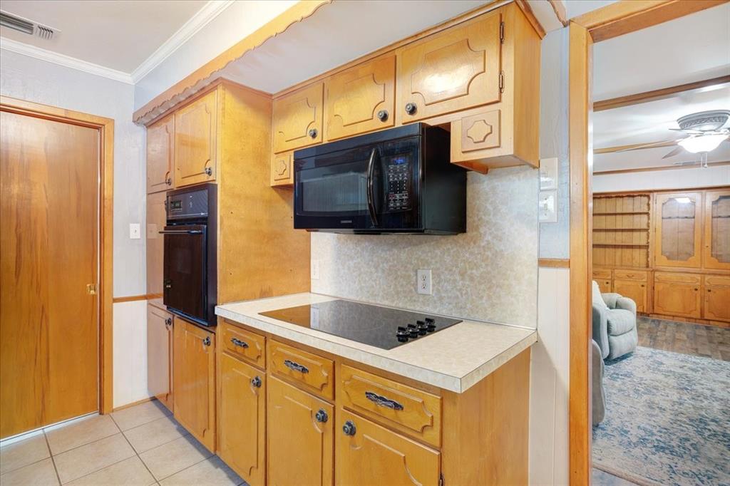 1418 Blanton Place Sherman, TX 75092 - Photo 11 of 33 a kitchen with stainless steel appliances a stove a microwave and a refrigerator