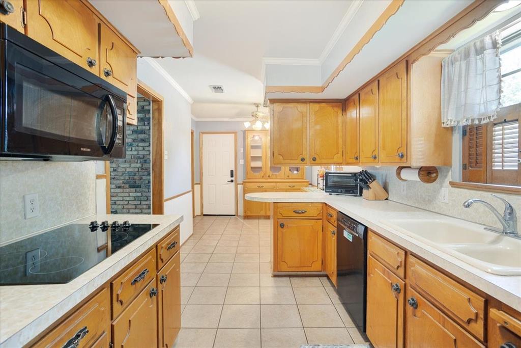 1418 Blanton Place Sherman, TX 75092 - Photo 12 of 33 a kitchen with stainless steel appliances granite countertop a sink and cabinets