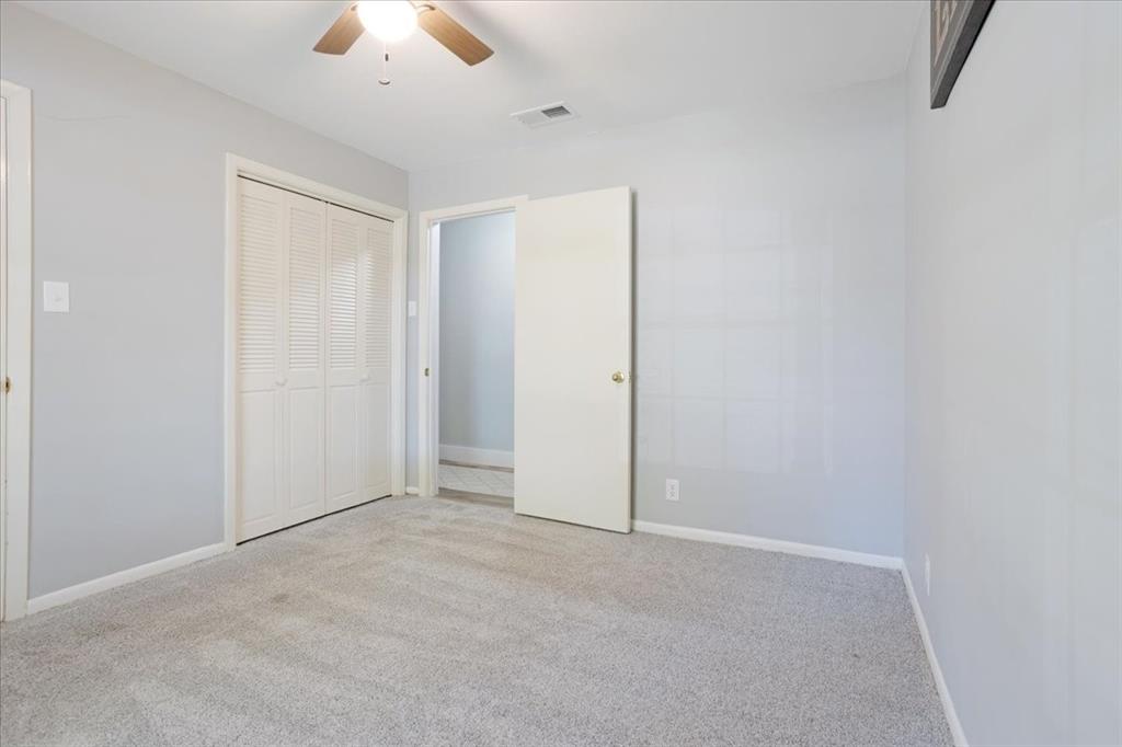 1418 Blanton Place Sherman, TX 75092 - Photo 20 of 33 an empty room with a ceiling fan and a window