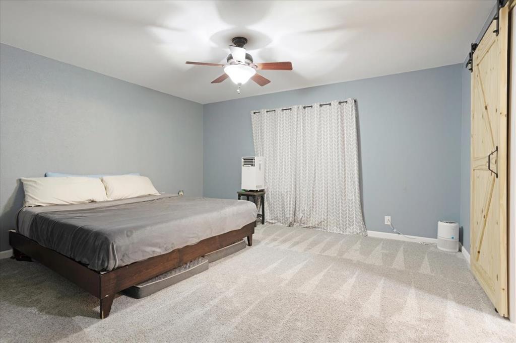 1418 Blanton Place Sherman, TX 75092 - Photo 21 of 33 a bedroom with a bed and a chandelier
