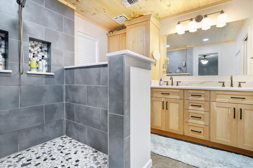 1418 Blanton Place Sherman, TX 75092 - Photo 24 of 33 a bathroom with a sink a mirror and a shower