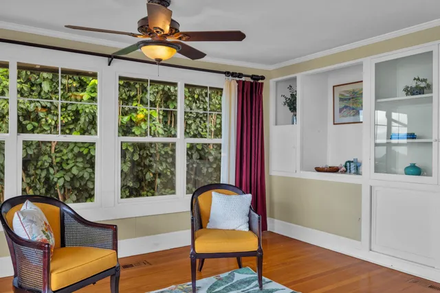 a view of a livingroom with a ceiling fan and window