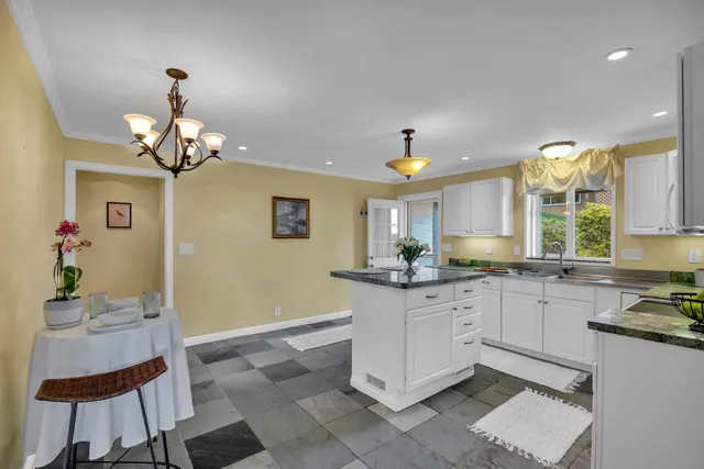 a kitchen with a table and chairs