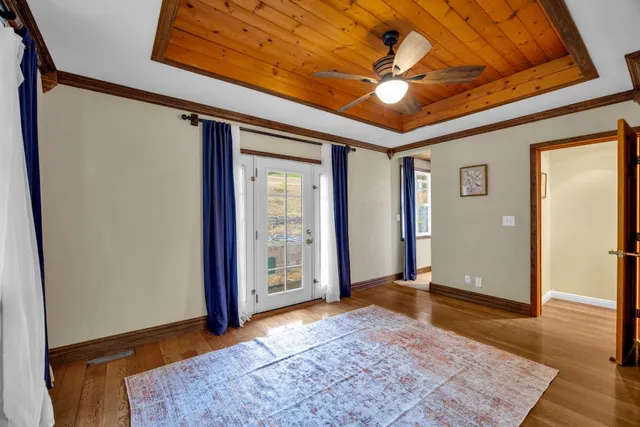 a spacious bedroom with a bed and a chandelier