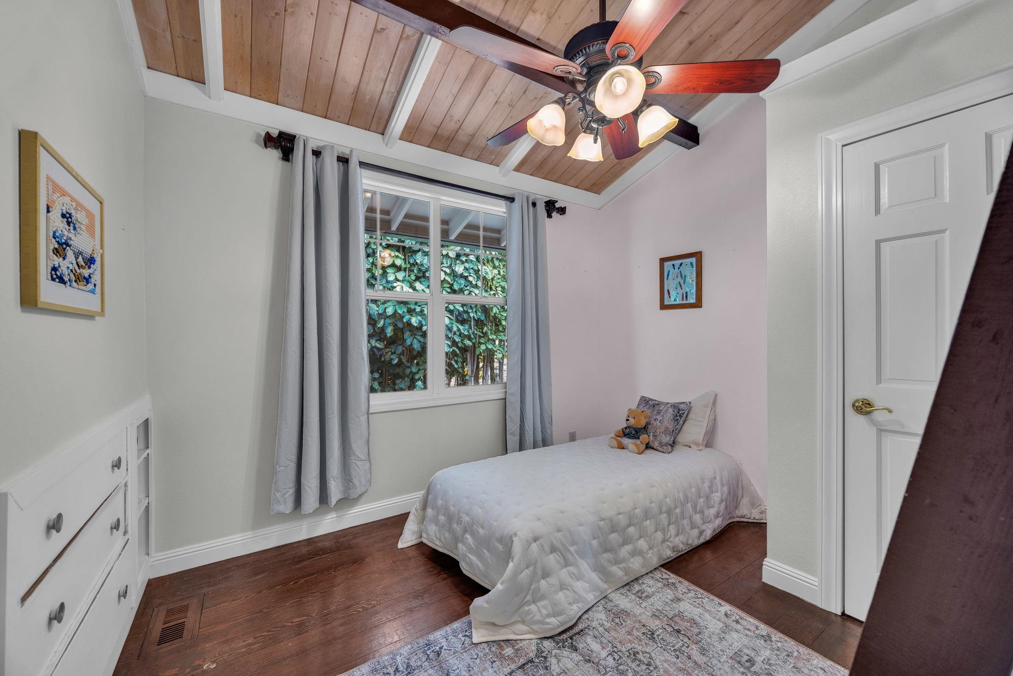 1123 Kehau Place Makawao, HI 96768 - Photo 39 of 50 a bedroom with a bed and a chandelier