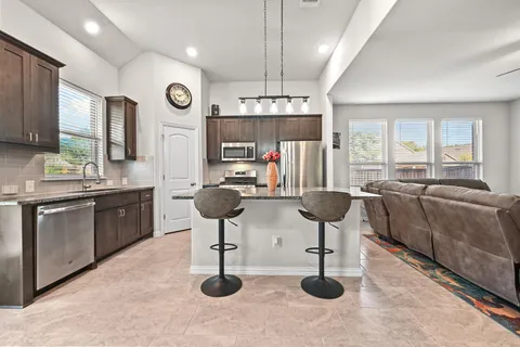a kitchen with lots of counter space furniture and windows