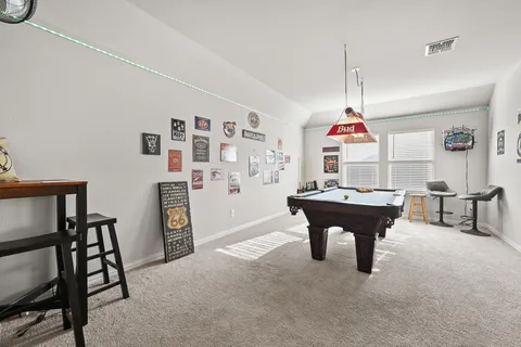 a living room with furniture a dining table and a window