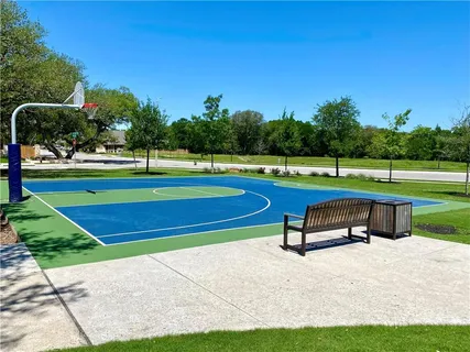 a park view with a bench and trees