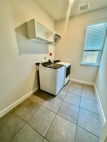 an empty room with a ceiling fan and a window