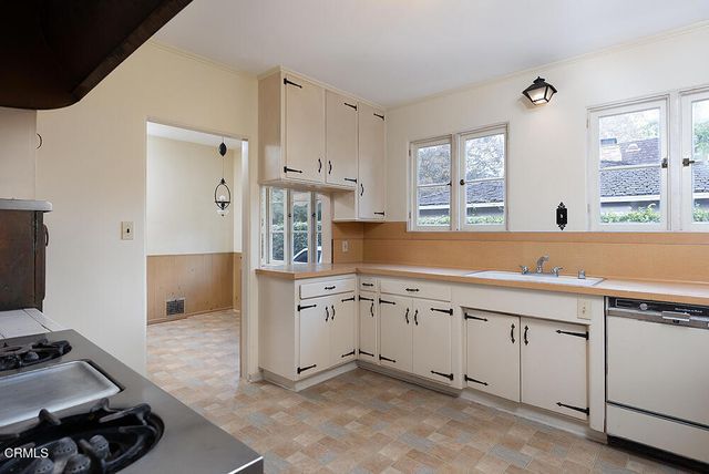 a kitchen with a stove a refrigerator and a stove