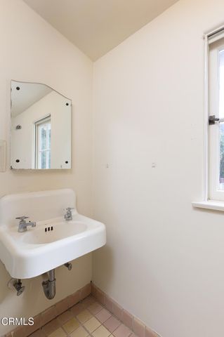 an empty room with wooden floor closet and windows