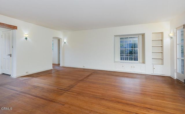 a view of cabinets a sink and a window in a room