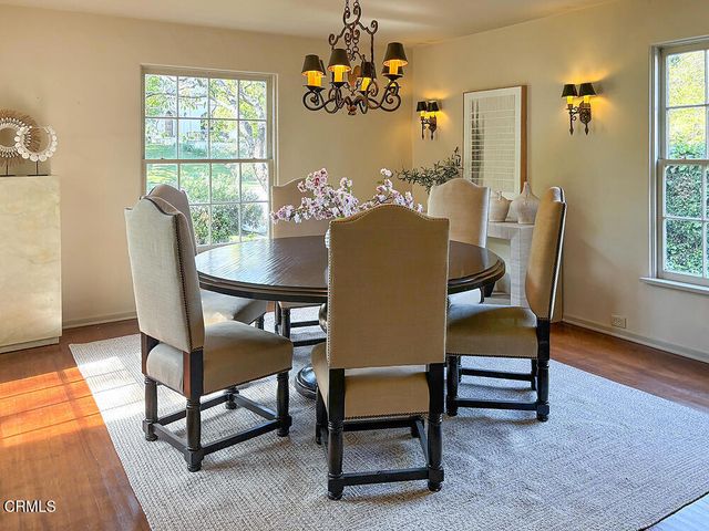 a dining room with furniture a rug and a chandelier