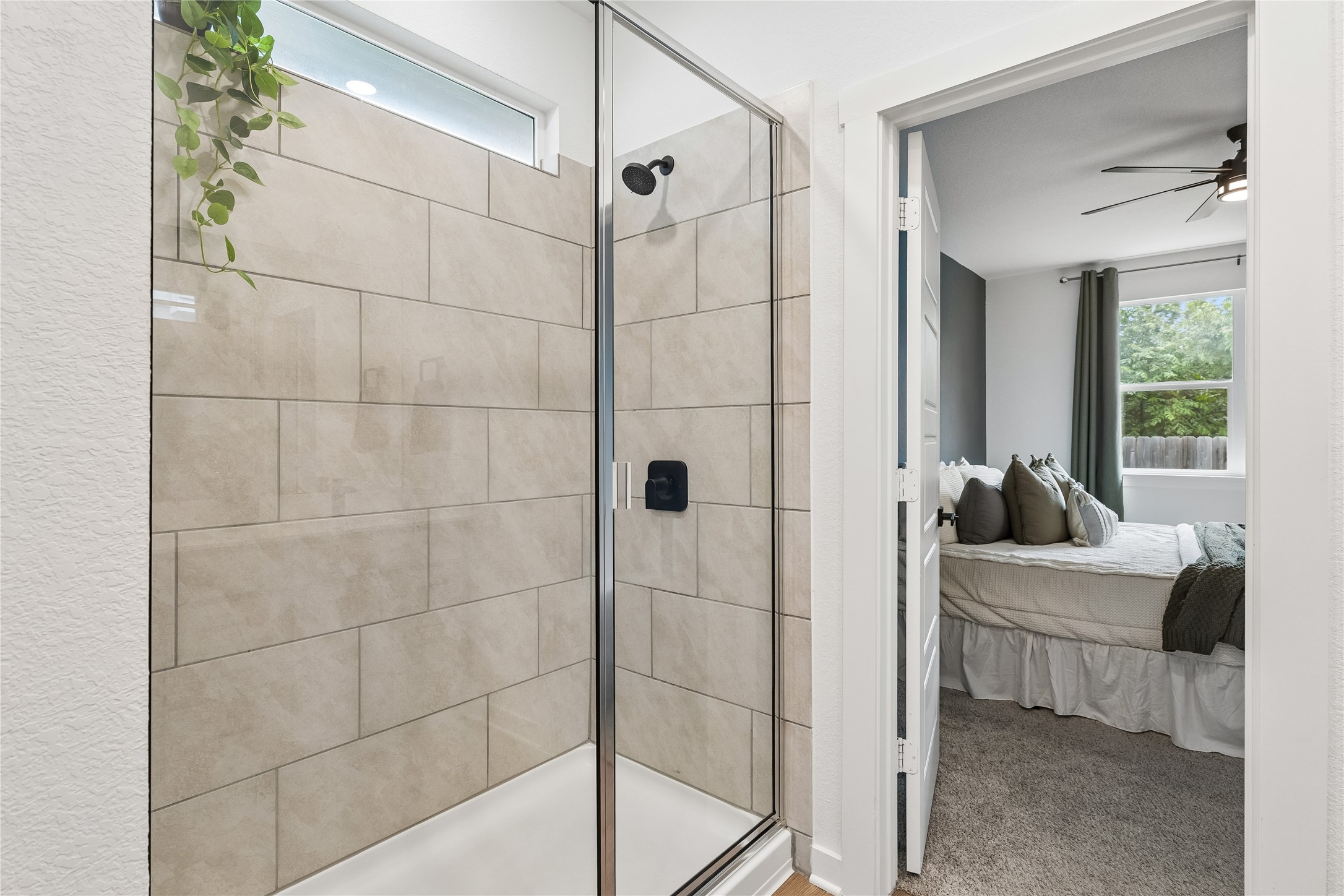 249 Century Plant Road Leander, TX 78641 - Photo 13 of 22 a bathroom with a bathtub and a shower