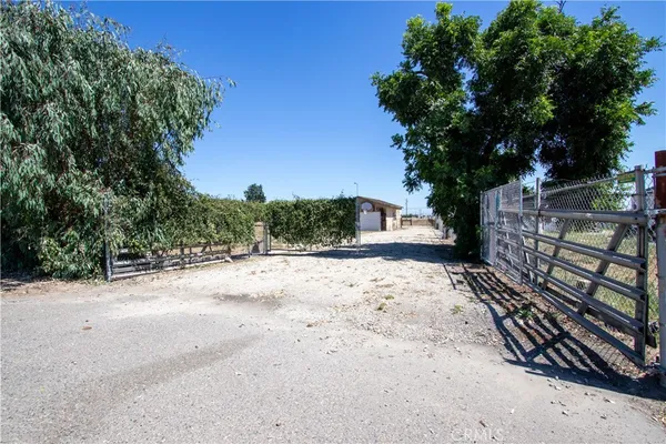 a view of a yard with wooden fence