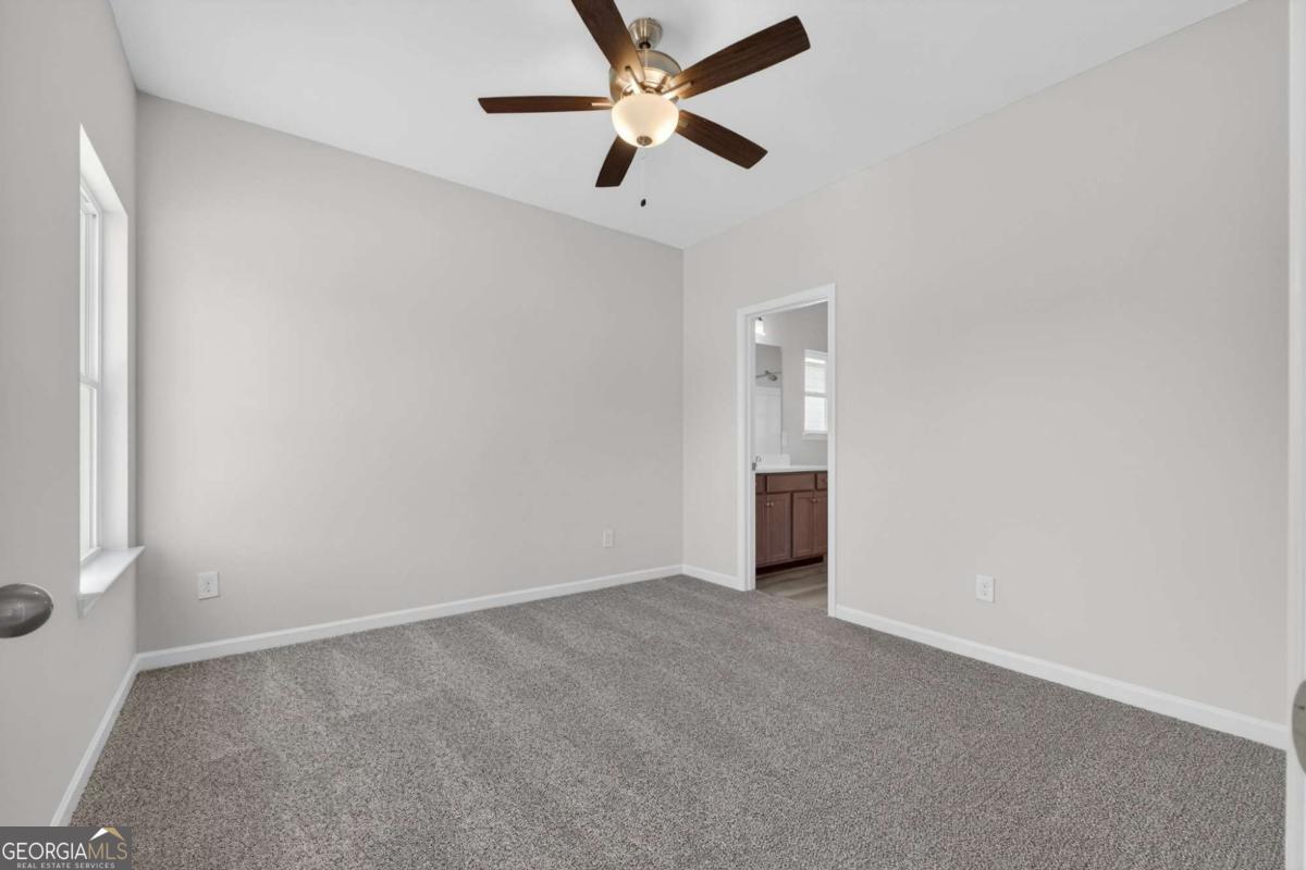 205 Riverview Road Franklin, GA 30217 - Photo 14 of 26 an empty room with closet and a ceiling fan