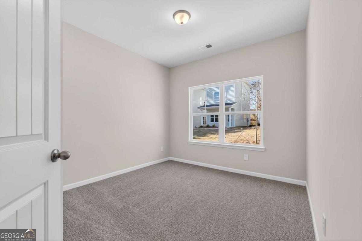 205 Riverview Road Franklin, GA 30217 - Photo 18 of 26 a view of an empty room with a window