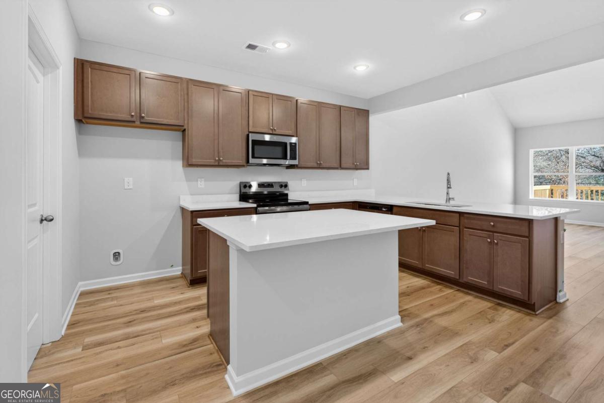 205 Riverview Road Franklin, GA 30217 - Photo 7 of 26 a kitchen with stainless steel appliances a sink stove and cabinets