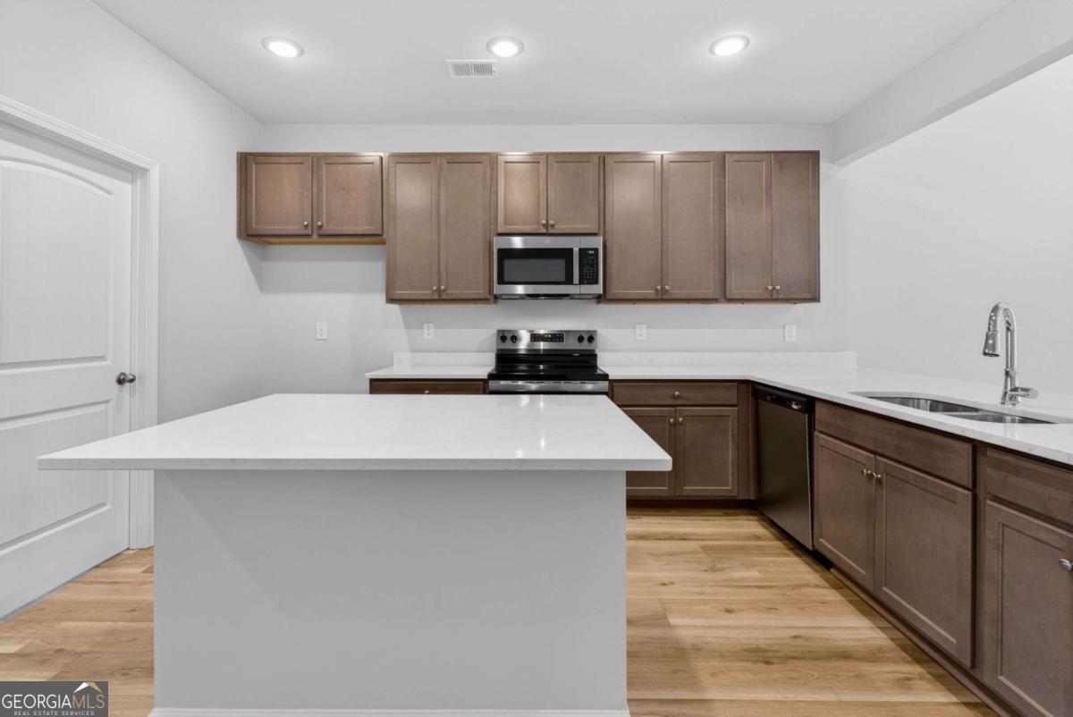 205 Riverview Road Franklin, GA 30217 - Photo 8 of 26 a kitchen with a sink a stove and cabinets